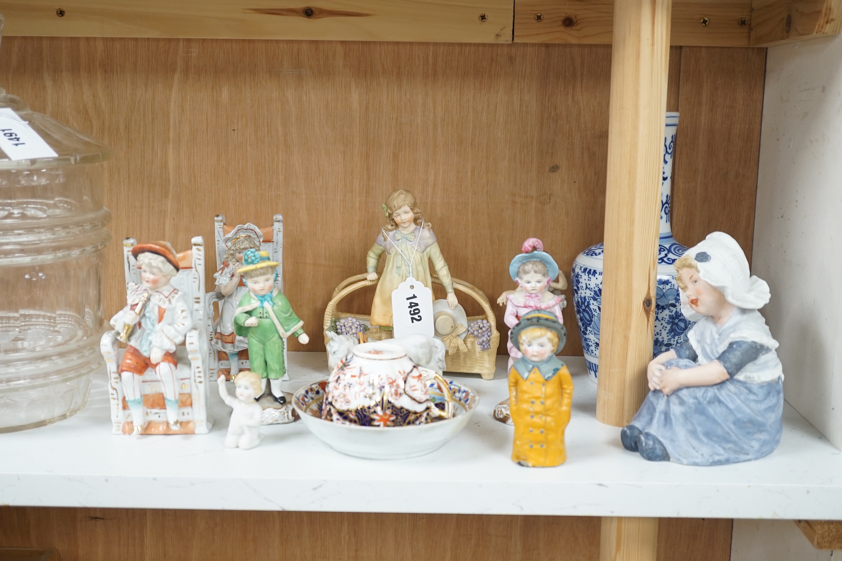 Twelve German and English porcelain items, mainly figures by Ernst Bohn, etc. a Staffordshire cup and saucer, blue and white vase, etc. vase 24cm